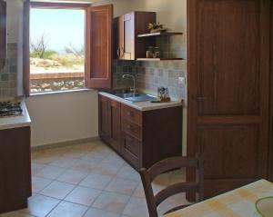 a kitchen with a sink and a window at Torre Russo in Guardavalle