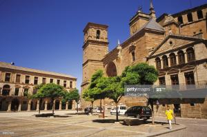 a man walking in front of a building with a clock tower at CENTRO HISTORICO in Manzanares