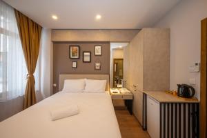 a bedroom with a large white bed and a desk at TAKSİM SUİTE in Istanbul