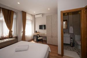 a hotel room with a bed and a bathroom at TAKSİM SUİTE in Istanbul