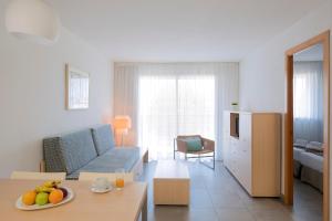 a living room filled with furniture and a table at Apartaments Cye Salou in Salou