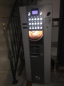a vending machine with a clock on top of it at Hostal Paco´s in Seville