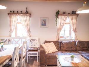a living room with a couch and a table at Chalupa U potůčku in Velké Losiny
