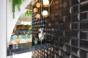 a wall covered in black tiles with lights on it at Vila Reyna in Constanţa