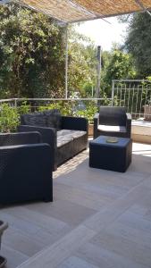 a patio with two couches and a coffee table at Stabiaeflor Apartment in Castellammare di Stabia