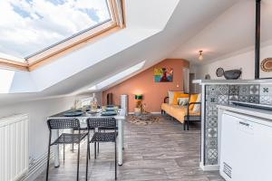 a living room with a table and chairs and a couch at L'abstrait Metz Thionville Wifi Un-Séjour-à-Part in Mondelange