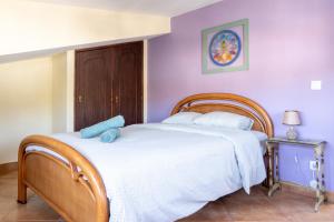 a bedroom with a bed with a blue stuffed animal on it at Natural Mystic Hostel in Costa da Caparica