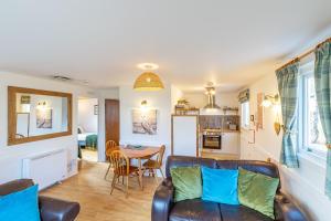 a living room with a couch and a table at Bracken Lodge 16 with Hot Tub in Belladrum