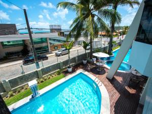 a swimming pool on a balcony with a view of a street at Rede Andrade Bello Mare in Natal
