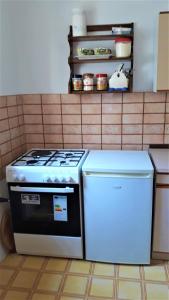 a stove and a refrigerator in a kitchen at Apartment Modric in Senj