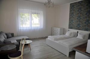 a living room with a bed and a couch at River Apartment in Makó