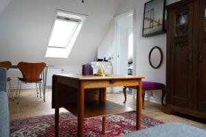 a living room with a table and chairs at Homely 2 room Apartment close to Copenhagen city center in Copenhagen