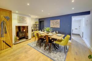 a dining room with a table and chairs and a fireplace at Church Bells House by Spa Town Property - 3 Bedroom Georgian Townhouse in Central Warwick in Warwick
