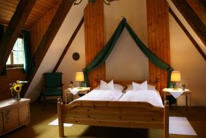 a bedroom with a bed with a green canopy at Schloss Egg in Bernried