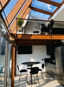 a room with a table and chairs in a kitchen at Sea & Sunset View Apartment In Palanga in Palanga +17 photos