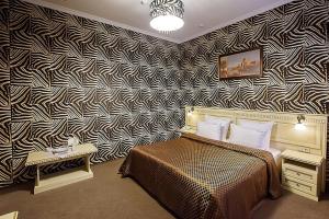 a bedroom with a black and white patterned wall at Прага in Krasnodar