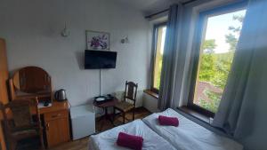 a bedroom with a bed and a large window at Pensjonat David in Świeradów-Zdrój