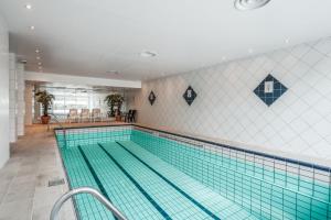 a large swimming pool with a tile wall at Ustedalen Resort Leiligheter in Geilo