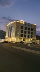 a large building on a street with a parking lot at Cladium Hotel in Al Madinah