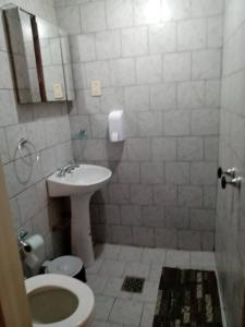 a bathroom with a toilet and a sink at Departamentos Fuentes in Cipolletti