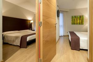 Säng eller sängar i ett rum på Hotel Plazaola