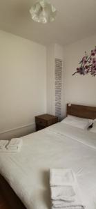 a bedroom with a bed with two towels on it at APARTMAN DEDA in Rakovica