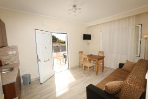 a living room with a couch and a table at Angelos Apartments in Lixouri