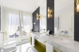 a bathroom with two sinks and two toilets at Grand Hotel Principe Di Piemonte in Viareggio