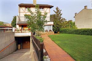 a house with a fence and a grass yard at Casa Escardill in La Seu d'Urgell