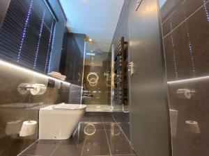 a bathroom with a toilet and a shower at The Bold Hotel; BW Signature Collection in Southport