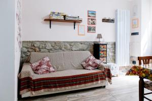 a living room with a couch with pillows on it at La Poventa in Tuoro sul Trasimeno