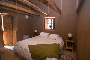 a bedroom with a large bed in a room with wooden ceilings at Hotel Casona Distante in Alcoguaz