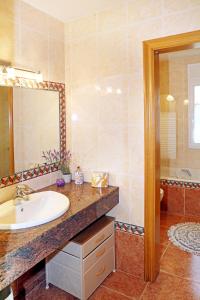 a bathroom with a sink and a mirror at Casa Escardill in La Seu d'Urgell