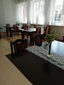 a dining room with a table with a vase on it at Hotel Fregata in Pęczniew