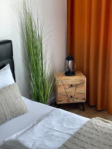 a bedroom with a bed and a table with a tea kettle on it at SOLE Apartment 2 in Satu Mare