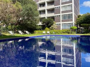 a swimming pool in front of a building at Cape Breaks in Cape Town