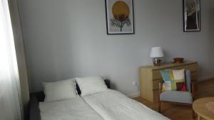 Łóżko lub łóżka w pokoju w obiekcie Apartament na Jeziornej