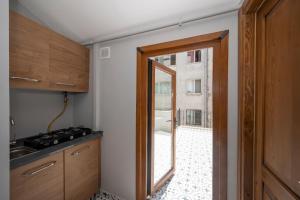 a kitchen with a door leading to a patio at TAKSİM SUİTE in Istanbul