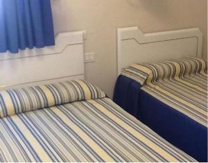 A bed or beds in a room at Apartamentos Buenavista II