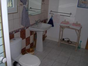 a bathroom with a toilet and a sink at Les Blancarts in Hautebut