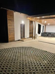 a room with a brick floor in front of a building at Cabana The Lux in Beclean