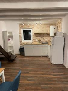 a kitchen with white appliances and a brick wall at Cabana The Lux in Beclean