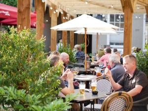 a group of people sitting at tables in a restaurant at The Falcon Hotel in Bridgnorth