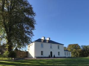 a white house with a black roof at Andresna House in Corrigeenroe