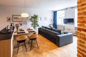 a living room with a couch and a table at OnLviv Apartments Rynok Square 18/2 in Lviv