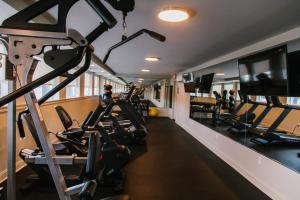 a gym with treadmills and cardio machines in it at Hotel Legends in Biloxi