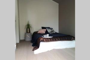 a bedroom with a bed with a table on it at Gjermundsøya Brygge in Ballstad