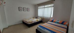 Postel nebo postele na pokoji v ubytování Amplio Apartamento en Los Colores