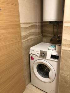 a washer and dryer in a small room at Wonderful Studio Apartment in Skopje center in Skopje