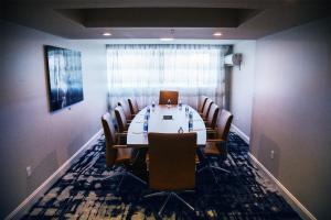 a conference room with a long table and chairs at Hotel Legends in Biloxi